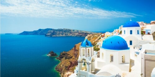 white buildings with blue seas - how to become an international real estate agent