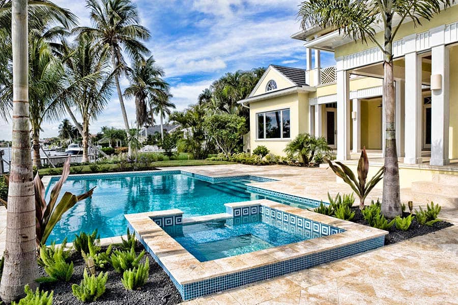 Florida real estate with a pool surrounded by palm trees