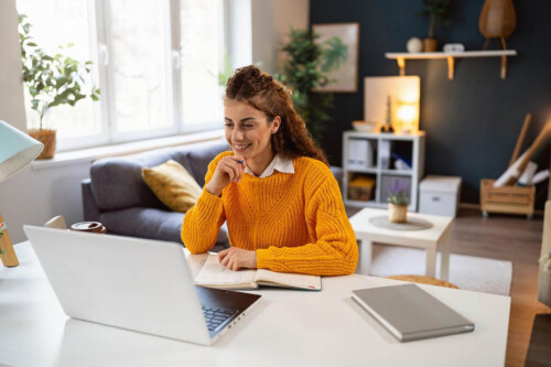 woman looks at computer to contemplate best career change jobs